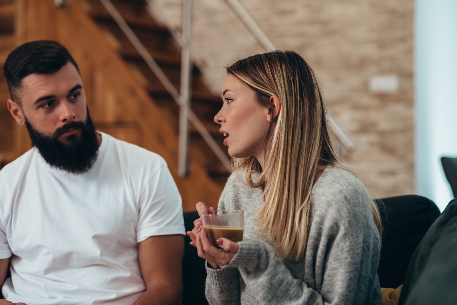 Two colleagues in a candid, supportive one-to-one conversation