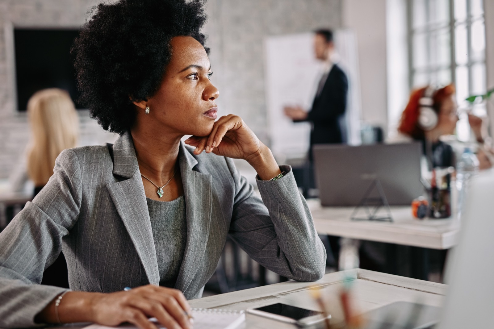 A learner pausing to think a situation through at her desk