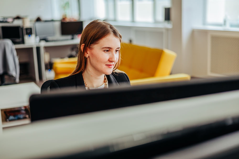 A newly promoted manager at her desk, figuring out the people part alone