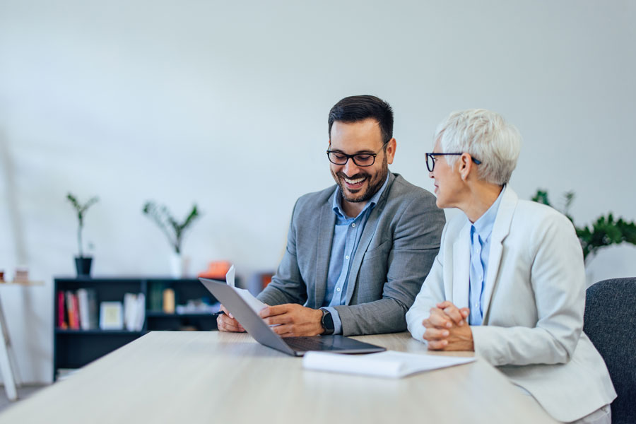 Two colleagues talking a decision through together, with AI in a supporting role